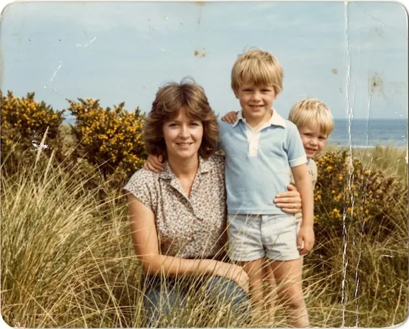 The same wide photo before restoration: scratched and underexposed.