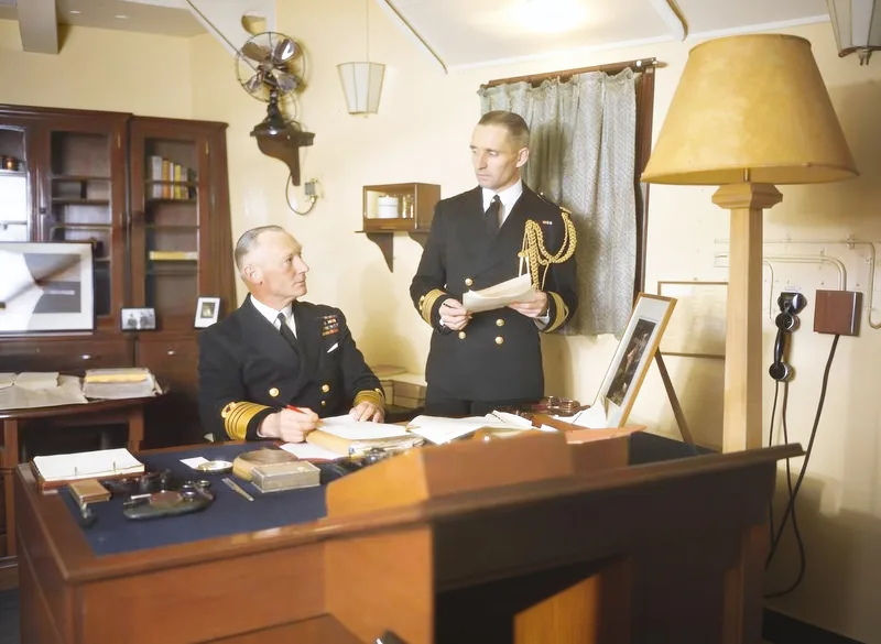 The same photo repaired: scratch gone, color corrected, uniforms and faces clear