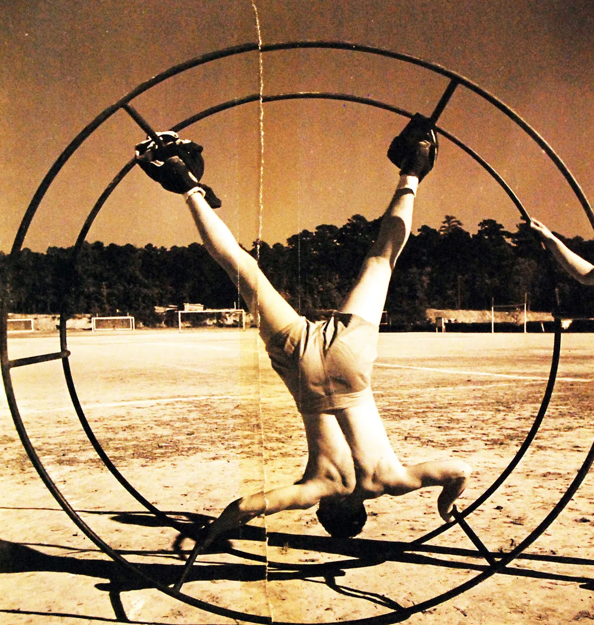 Cracked 1940s Navy training photo of a gymnast on a wheel apparatus
